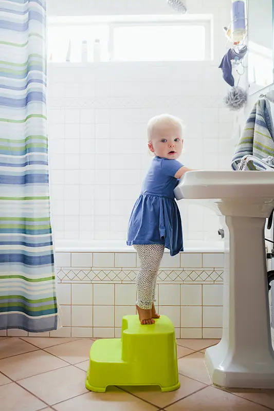 Toddler washing hands in the bathroom health photo