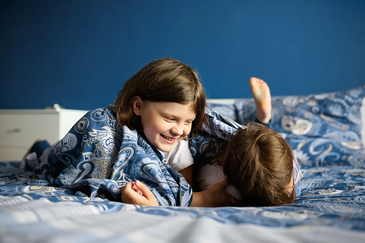 children-sisters-wake-up-on-the-bed-in-the-bedroom-2024-10-13-22-49-17-utc